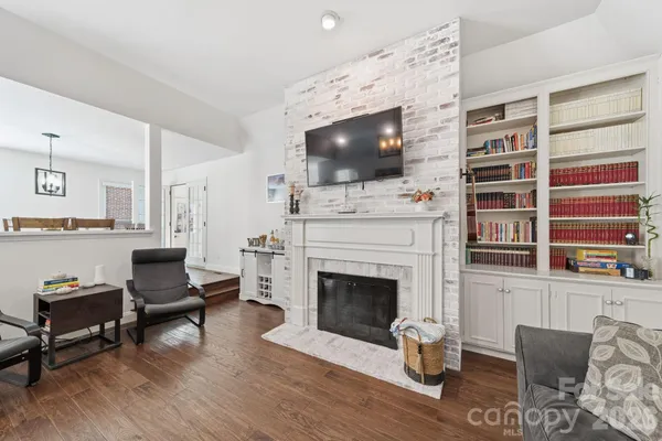 a living room with furniture fireplace and flat screen tv