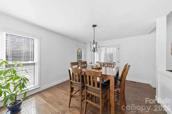 a view of a dining room with furniture and a potted plant