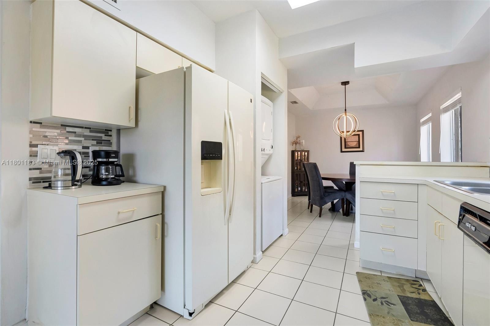 23158 Island View, Unit 1 Boca Raton, FL 33433 - Photo 23 of 39 a kitchen with a refrigerator and white cabinets