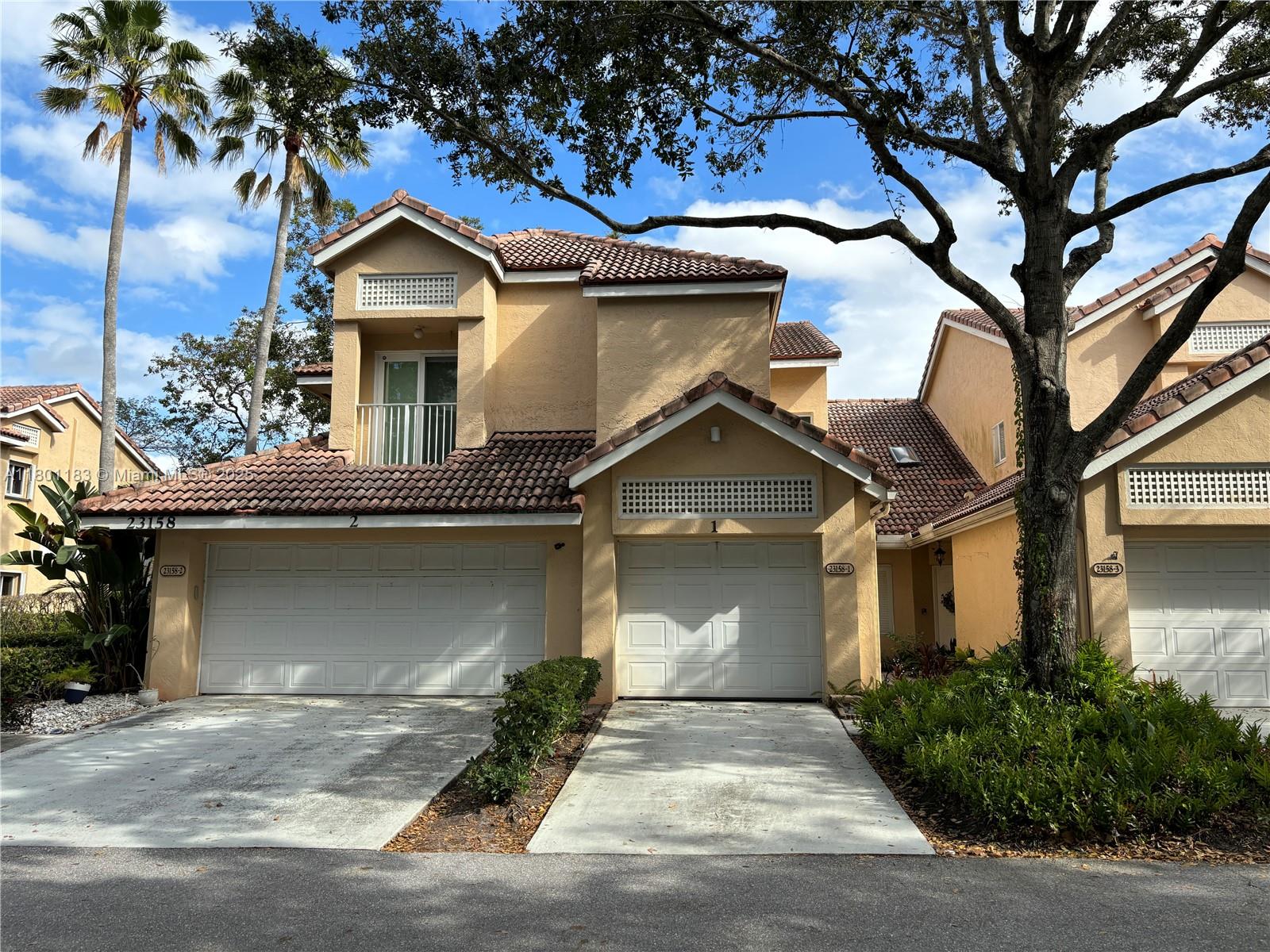 23158 Island View, Unit 1 Boca Raton, FL 33433 - Photo 28 of 39 front view of a house with a garage