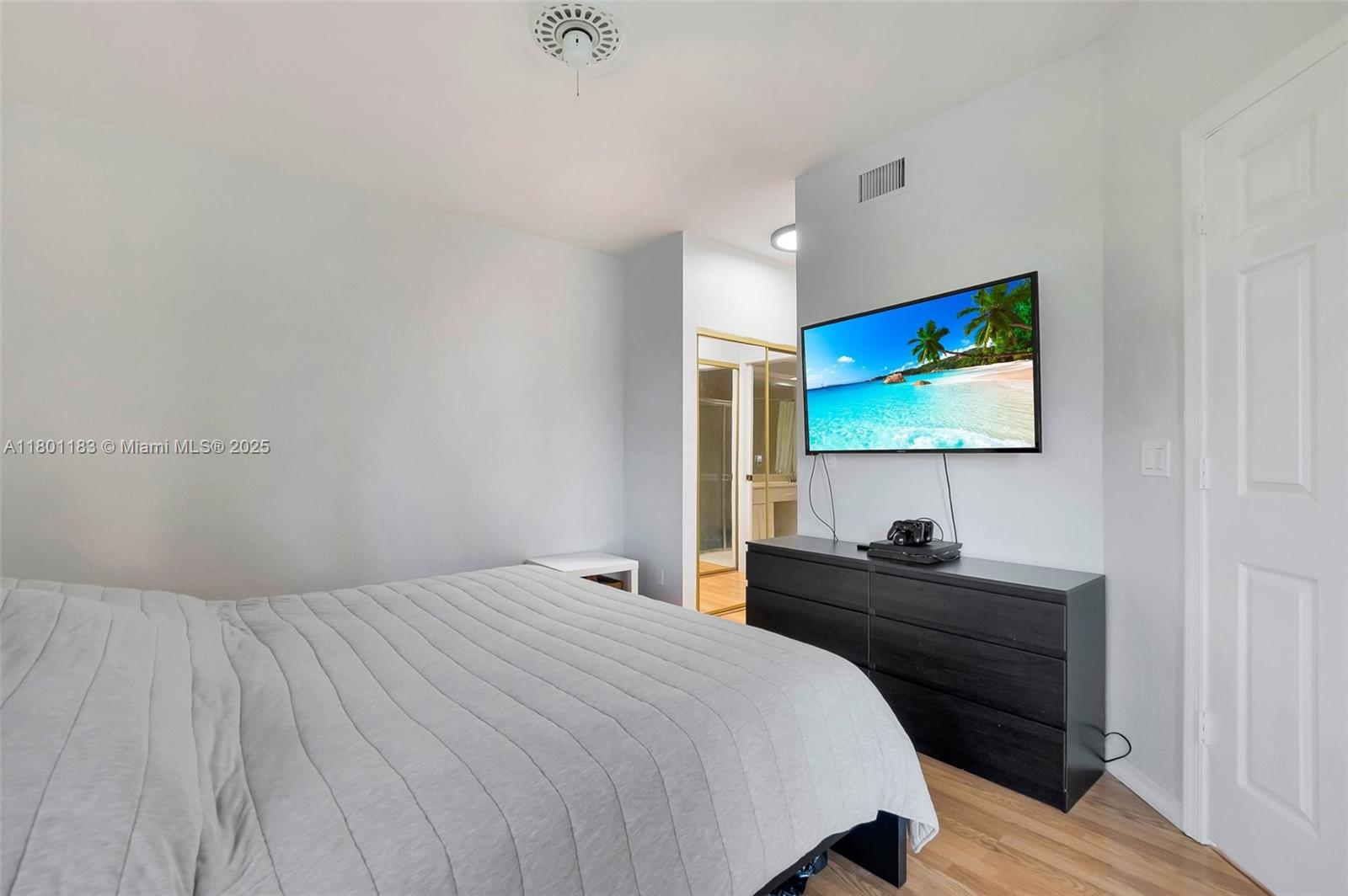23158 Island View, Unit 1 Boca Raton, FL 33433 - Photo 3 of 39 a bedroom with a bed and a flat screen tv