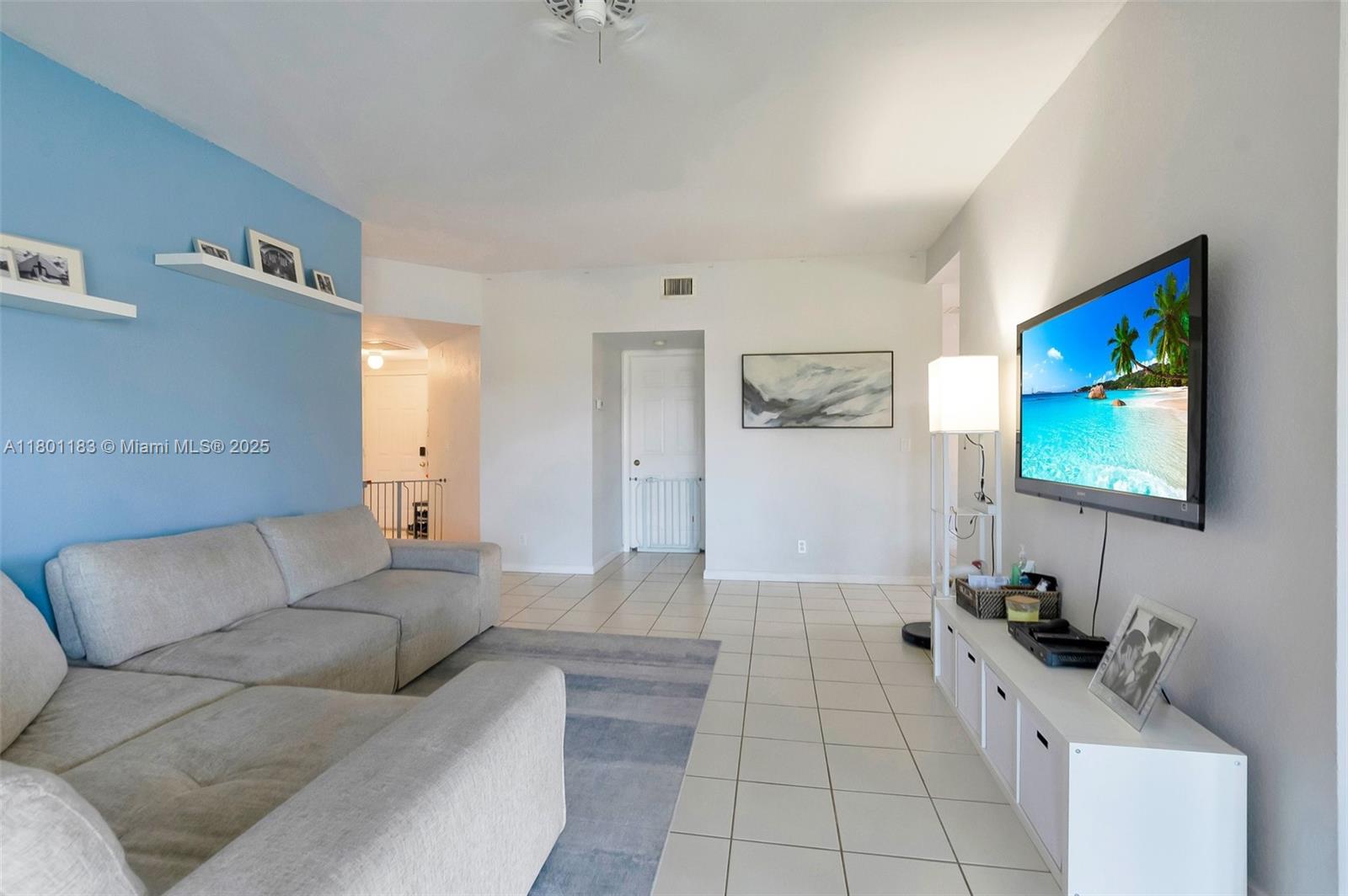23158 Island View, Unit 1 Boca Raton, FL 33433 - Photo 7 of 39 a living room with furniture and a flat screen tv