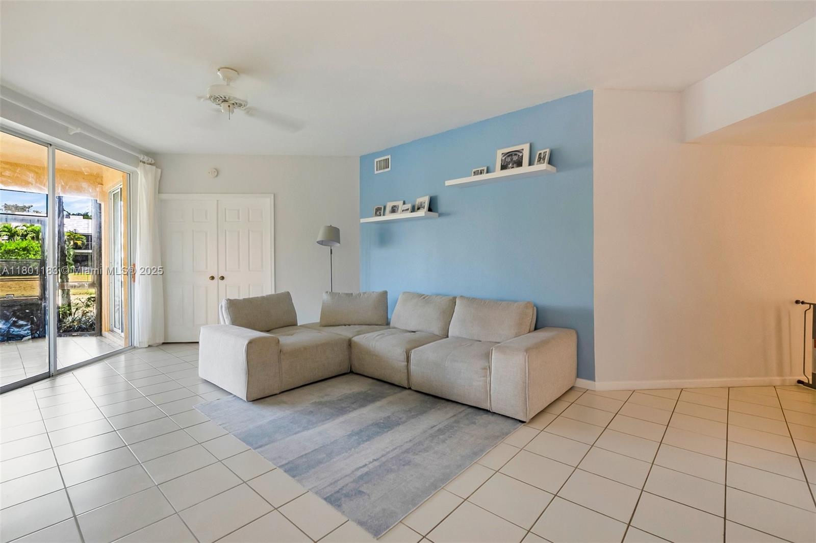 23158 Island View, Unit 1 Boca Raton, FL 33433 - Photo 8 of 39 a living room with furniture and a floor to ceiling window