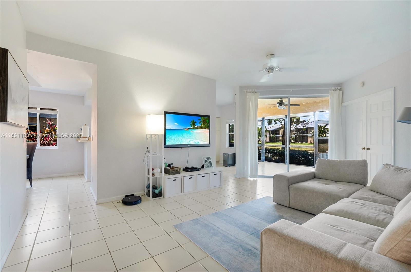 23158 Island View, Unit 1 Boca Raton, FL 33433 - Photo 9 of 39 a living room with furniture and a flat screen tv