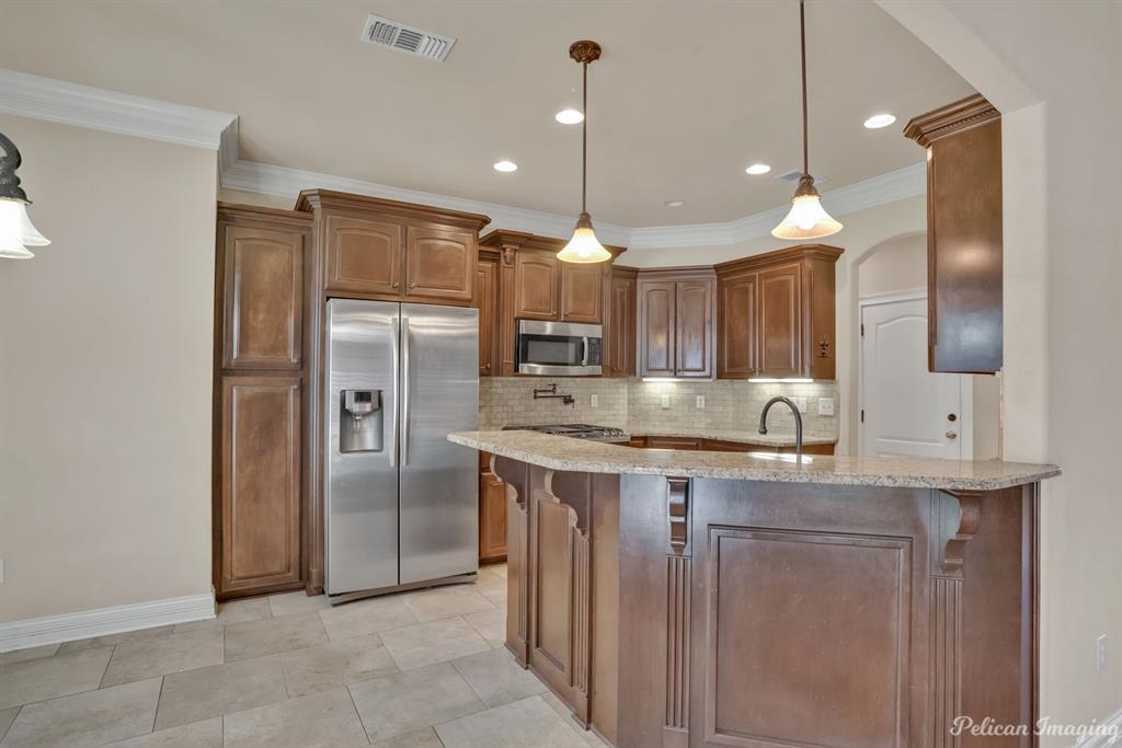 2805 Clearbrook Way Haughton, LA 71037 - Photo 11 of 36 a kitchen with kitchen island a sink and refrigerator