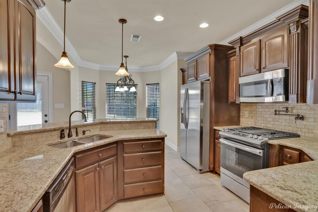 2805 Clearbrook Way Haughton, LA 71037 - Photo 13 of 36 a kitchen with stainless steel appliances granite countertop a sink stove and refrigerator