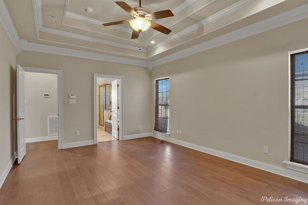 2805 Clearbrook Way Haughton, LA 71037 - Photo 17 of 36 an empty room with wooden floor fan and windows