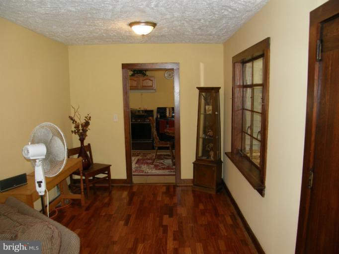 6885 Harmony Road Preston, MD 21655 - Photo 15 of 22 a view of a hallway to room with wooden floor and furniture