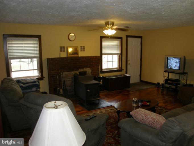 6885 Harmony Road Preston, MD 21655 - Photo 17 of 22 a living room with furniture and a fireplace