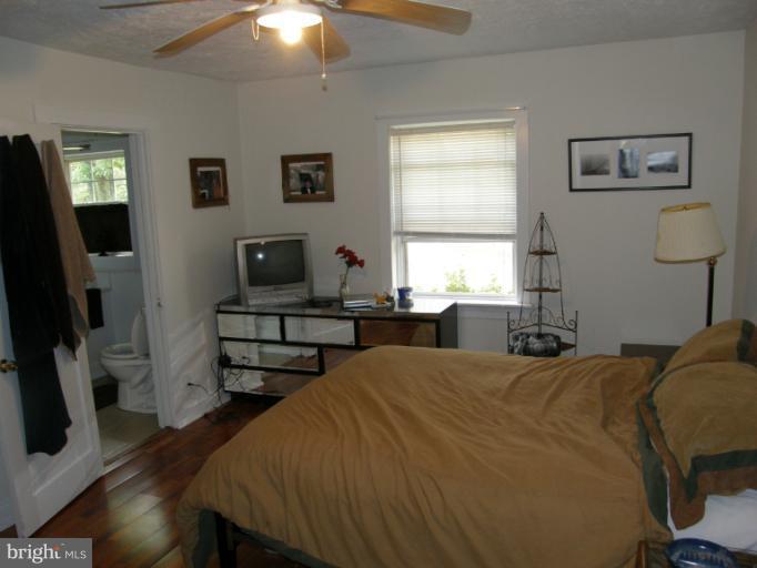 6885 Harmony Road Preston, MD 21655 - Photo 18 of 22 a bedroom with a bed and a flat screen tv