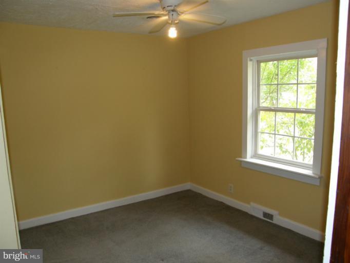 6885 Harmony Road Preston, MD 21655 - Photo 22 of 22 an empty room with a fan & a window