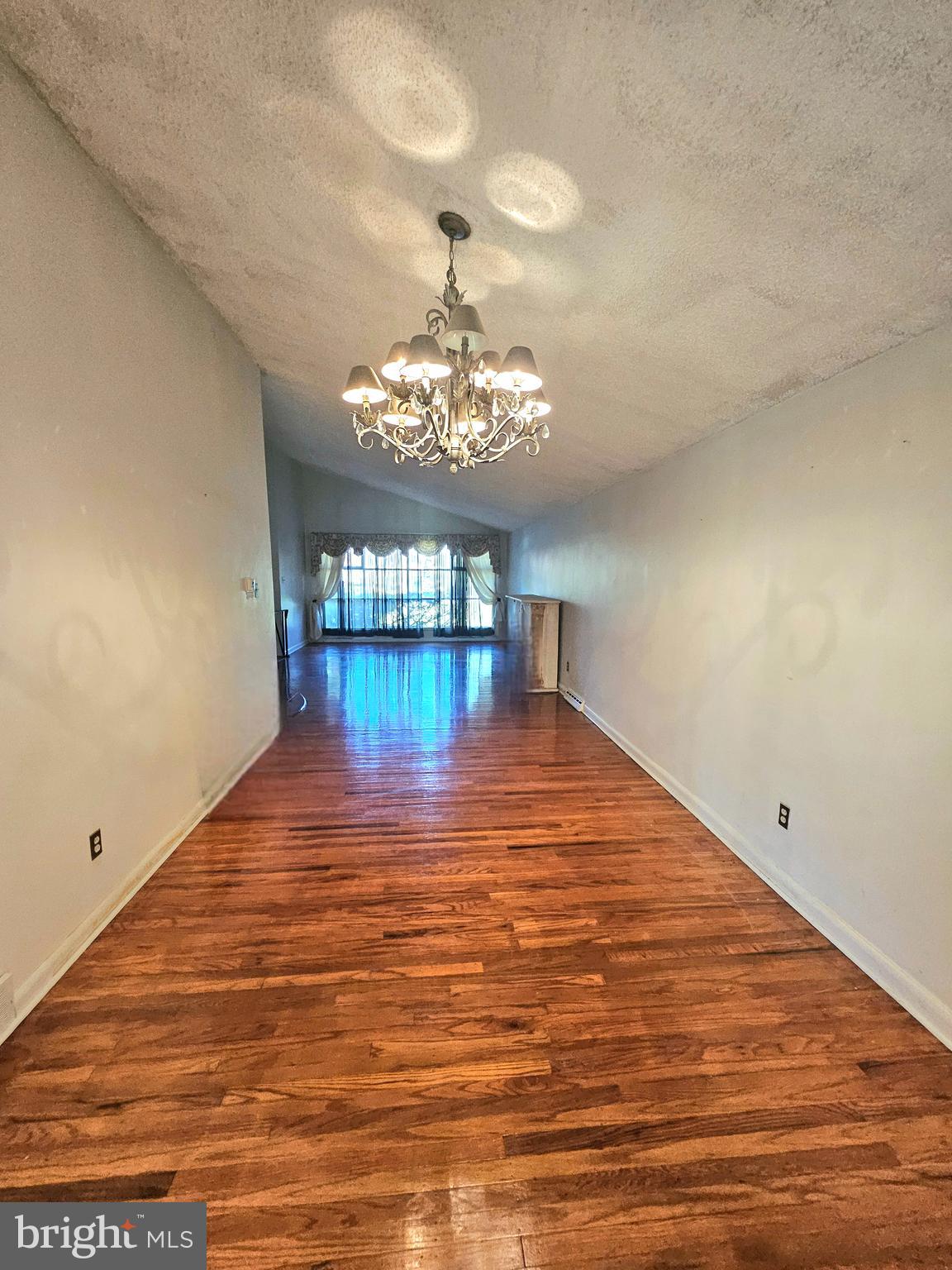 148 Church Road Elkins Park, PA 19027 - Photo 6 of 33 a view of empty room with chandelier and wooden floor