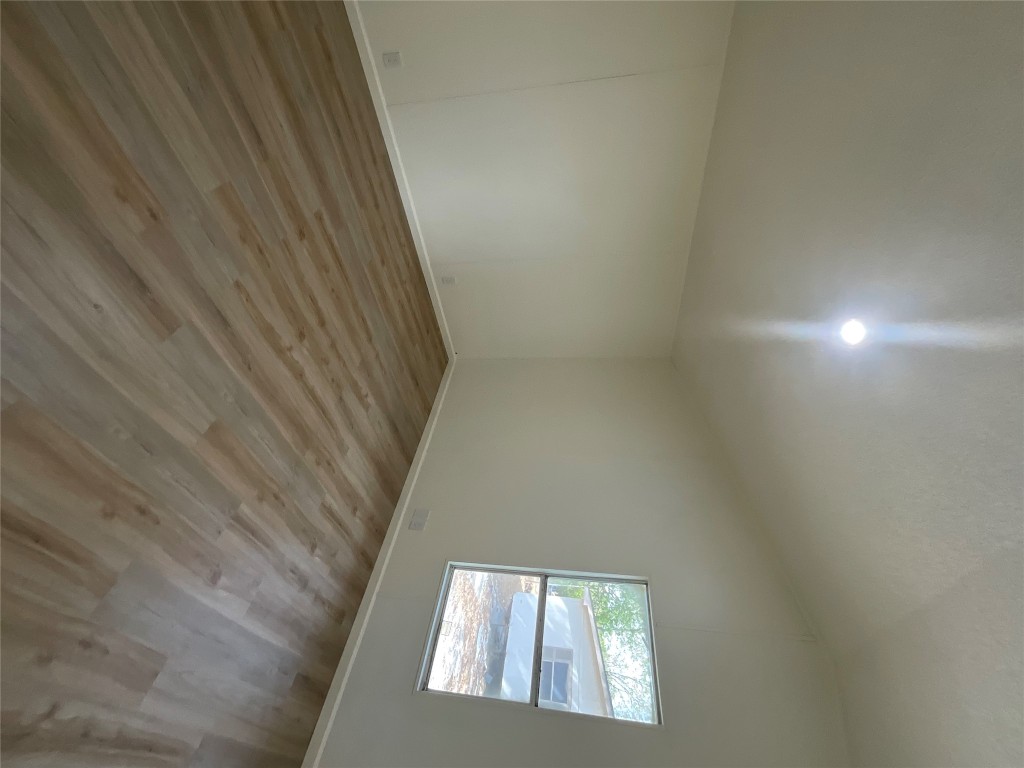 204 Overhill Road Bastrop, TX 78602 - Photo 15 of 18 an empty room with wooden floor and windows