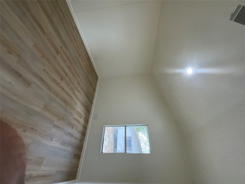 204 Overhill Road Bastrop, TX 78602 - Photo 16 of 18 an empty room with wooden floor and windows