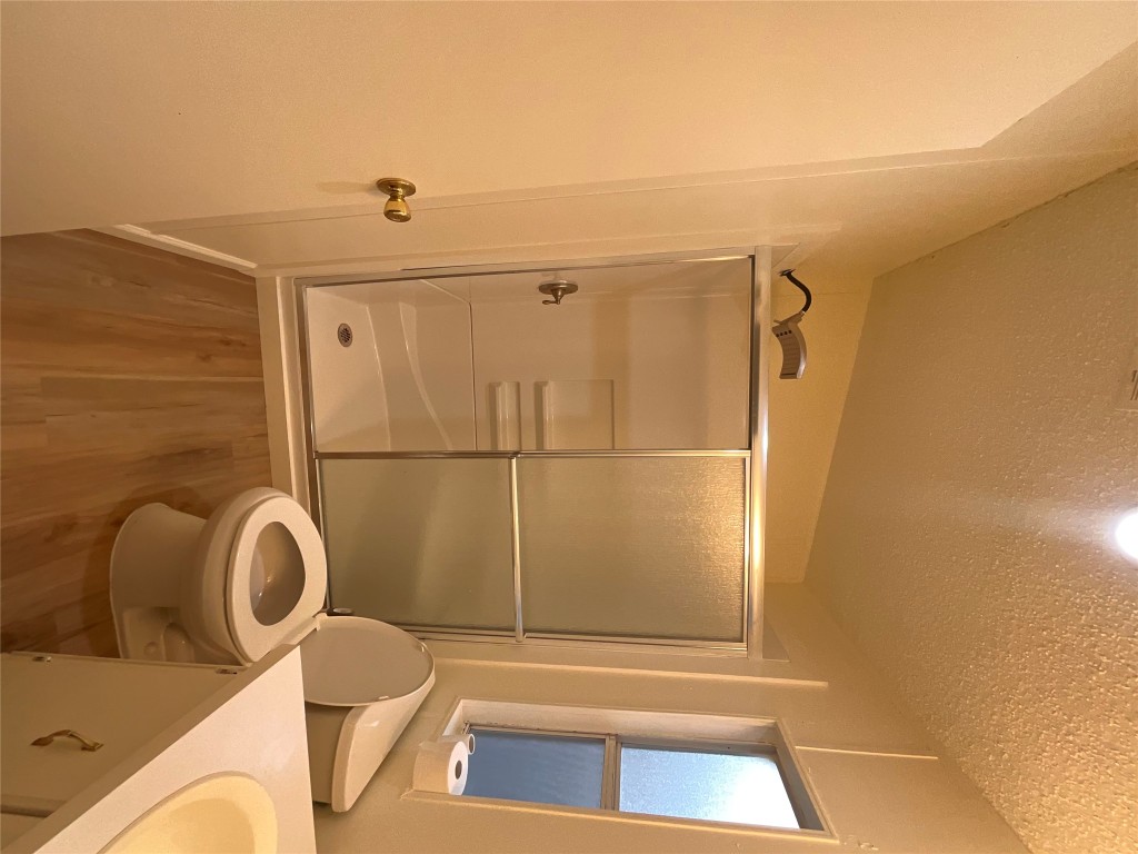 204 Overhill Road Bastrop, TX 78602 - Photo 17 of 18 a bathroom with a toilet a sink and shower