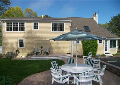 29 Alma Road Mashpee, MA 02649 - Photo 11 of 28 a view of a house with backyard sitting area and garden