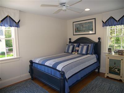 29 Alma Road Mashpee, MA 02649 - Photo 15 of 28 a bedroom with a bed a chandelier and a window