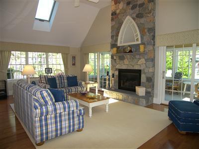 29 Alma Road Mashpee, MA 02649 - Photo 4 of 28 a living room with furniture a fireplace and a floor to ceiling window