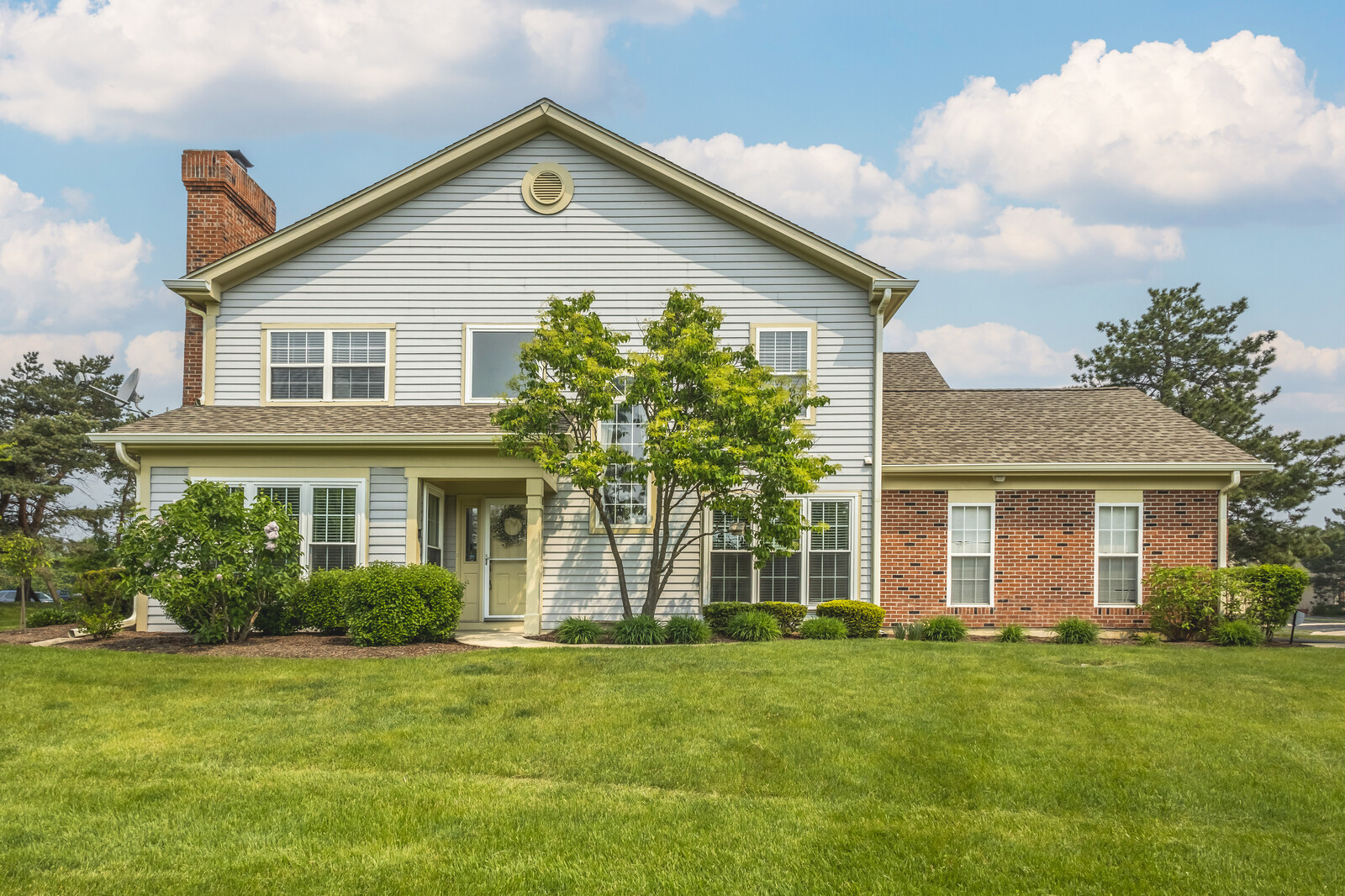 a front view of a house with a garden