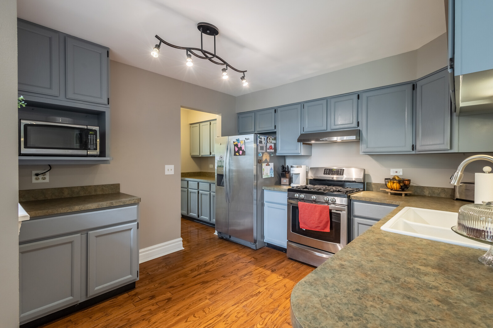 36102 North Springbrook Lane Gurnee, IL 60031 - Photo 8 of 21 a kitchen with stainless steel appliances granite countertop a stove refrigerator sink and microwave