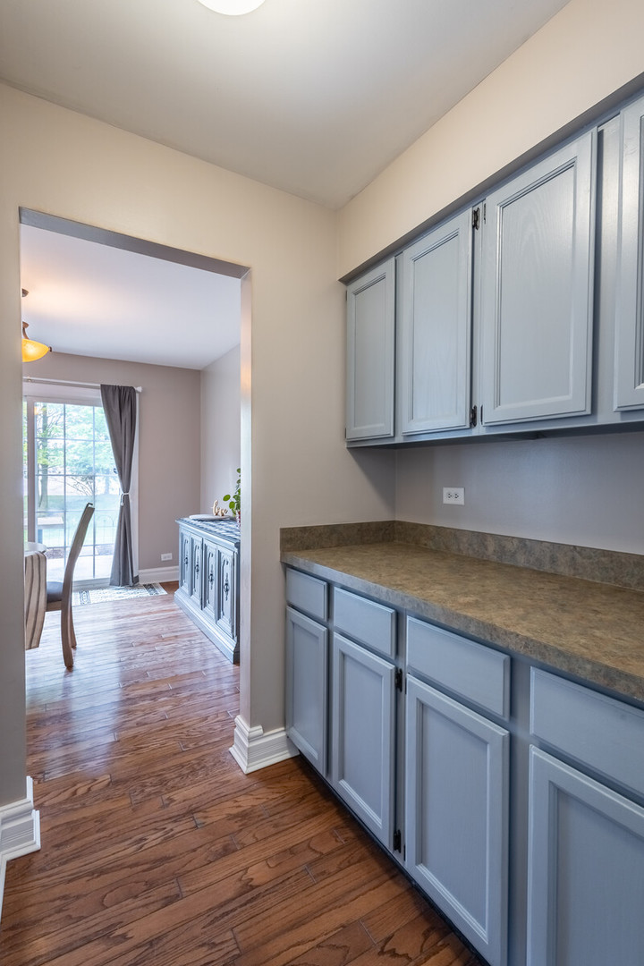 36102 North Springbrook Lane Gurnee, IL 60031 - Photo 10 of 21 a kitchen with wooden cabinets table and chairs