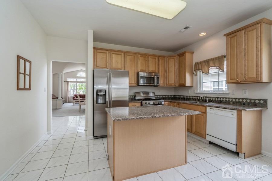 111 San Marco Road Monroe Township, NJ 08831 - Photo 13 of 31 a kitchen with stainless steel appliances granite countertop a refrigerator and a stove