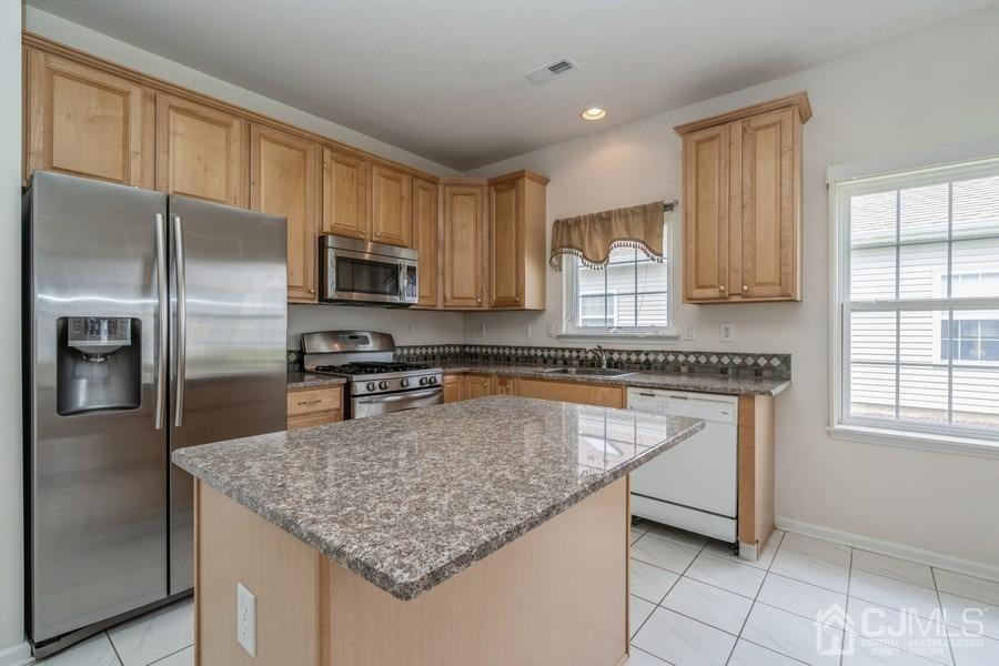 111 San Marco Road Monroe Township, NJ 08831 - Photo 14 of 31 a kitchen with stainless steel appliances granite countertop a sink stove and refrigerator
