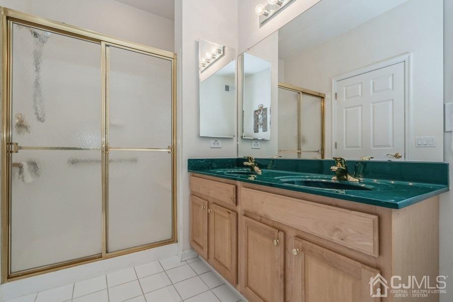 111 San Marco Road Monroe Township, NJ 08831 - Photo 26 of 31 a bathroom with a granite countertop sink and a mirror
