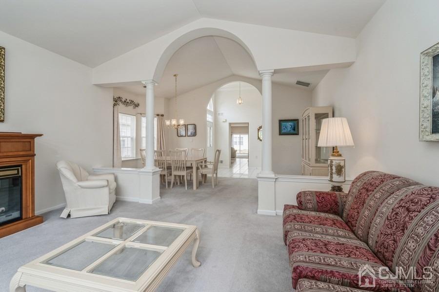 111 San Marco Road Monroe Township, NJ 08831 - Photo 6 of 31 a living room with furniture a table and chairs