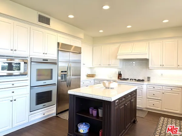 a kitchen with a sink stove and oven