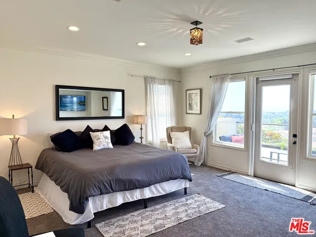 a bedroom with a large bed and a large window