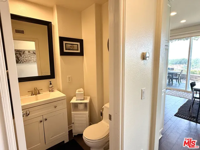 a bathroom with a toilet a sink and a mirror