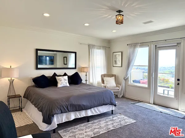 a bedroom with a large bed and a window