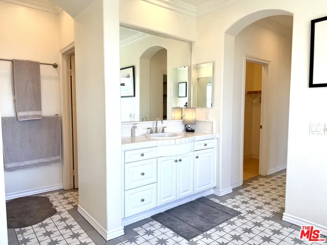 a bathroom with a double vanity sink and a mirror