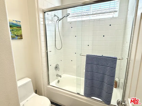 a bathroom with a shower and a toilet