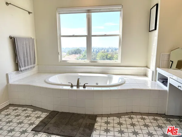 a bath tub sitting next to a window