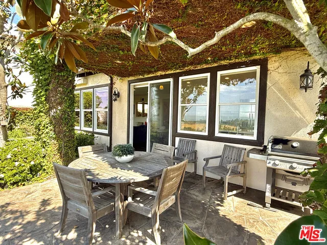 a dining room with furniture a chandelier and wooden floor
