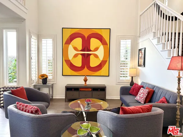 a living room with fireplace furniture and a large window