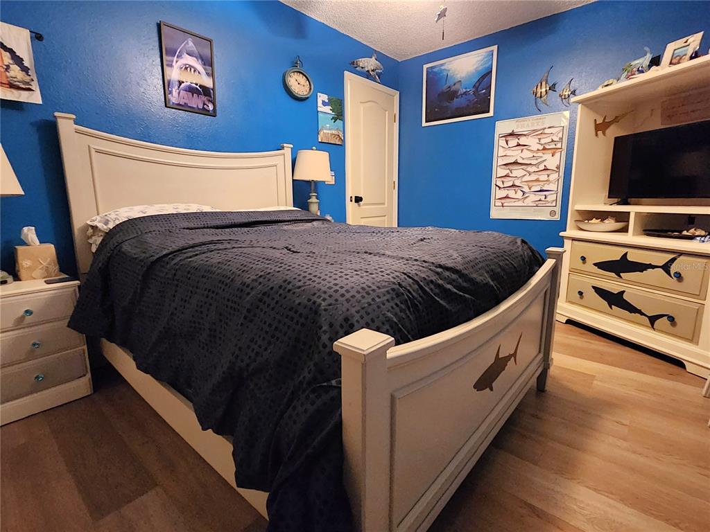 1701 Southeast 24th Road, Unit 1601 Ocala, FL 34471 - Photo 21 of 30 a bedroom with a bed and a flat screen tv