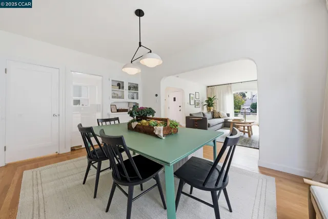 a view of a dining room with furniture and a potted plant