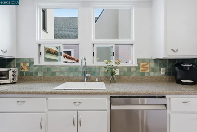 a view of a kitchen with wooden floor and electronic appliances