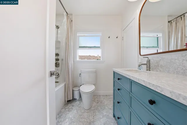 a bedroom with a bed dresser and a window