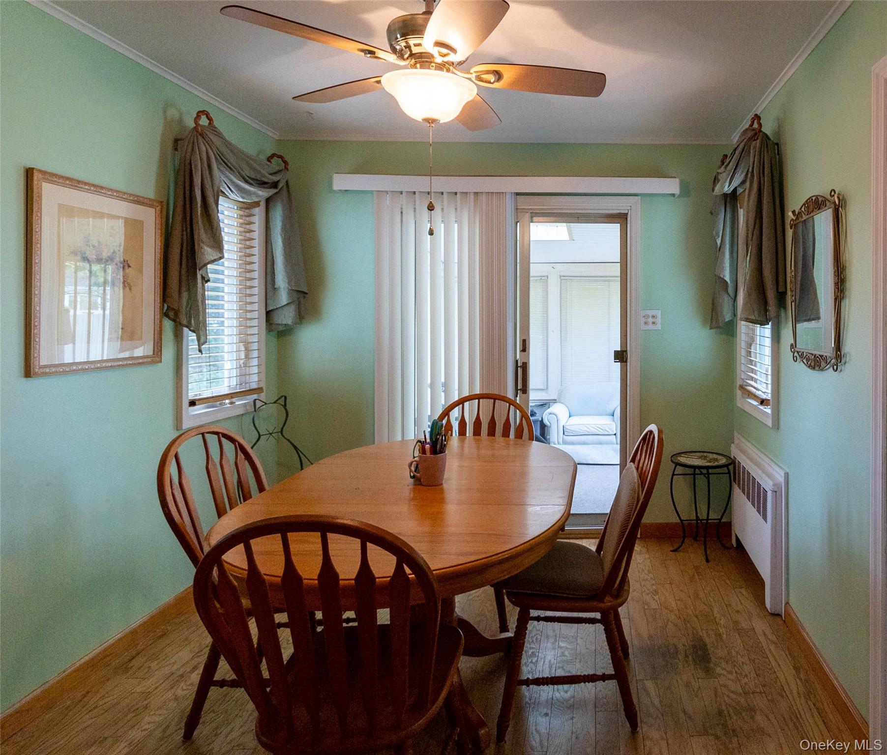 90 Sunset Road Bay Shore, NY 11706 - Photo 18 of 31 Dining area featuring wood-finish flooring and a ceiling fan with integrated lighting