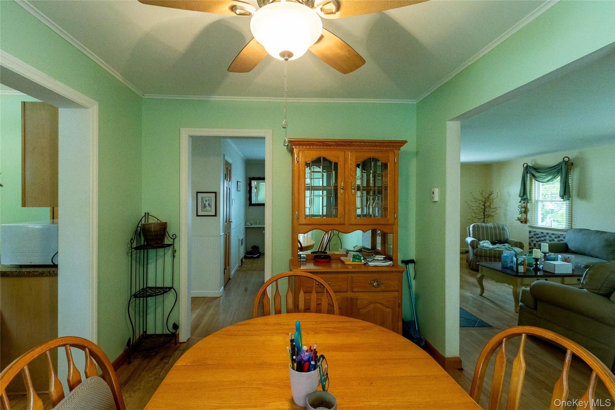 90 Sunset Road Bay Shore, NY 11706 - Photo 21 of 31 Dining area featuring wood-finish flooring and a ceiling fan with integrated lighting