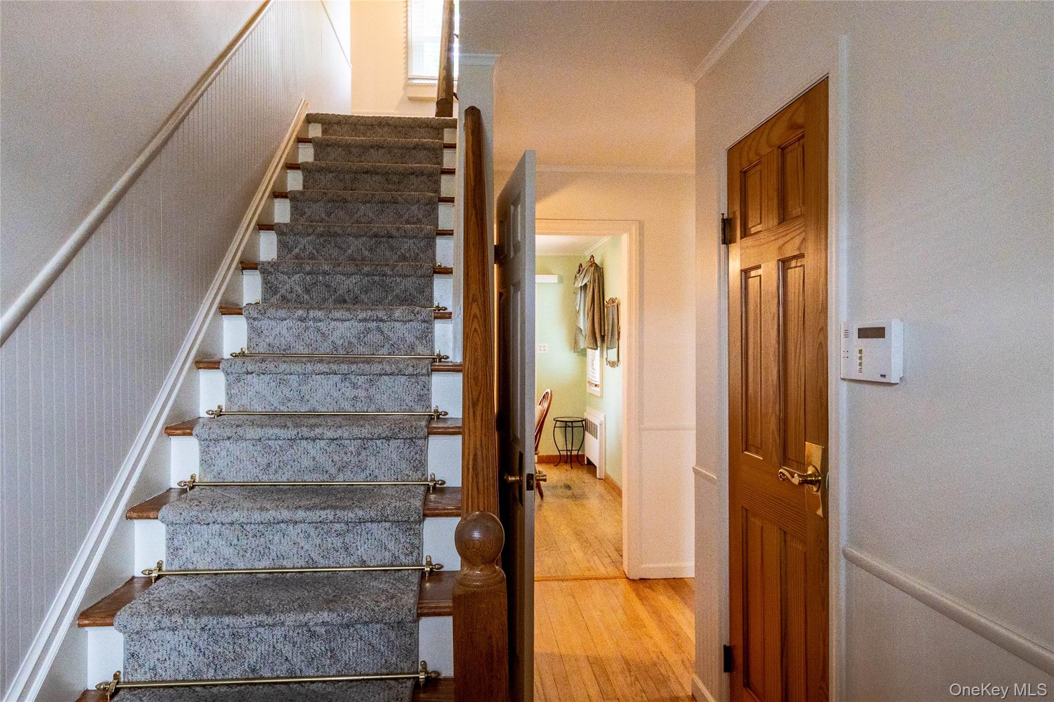 90 Sunset Road Bay Shore, NY 11706 - Photo 25 of 31 Hardwood staircase with carpet runner and brass stair rods