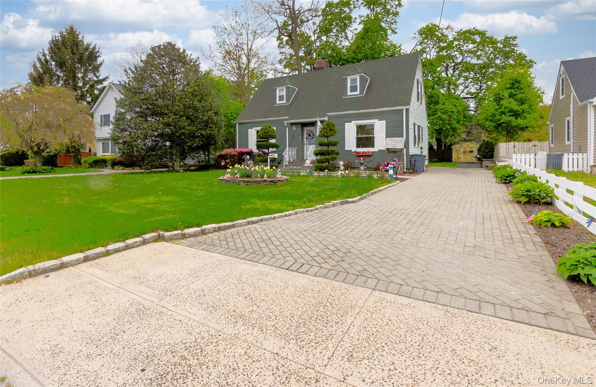 90 Sunset Road Bay Shore, NY 11706 - Photo 3 of 31 Cape Cod style home featuring a gabled roof, dormer windows, and white window shutters