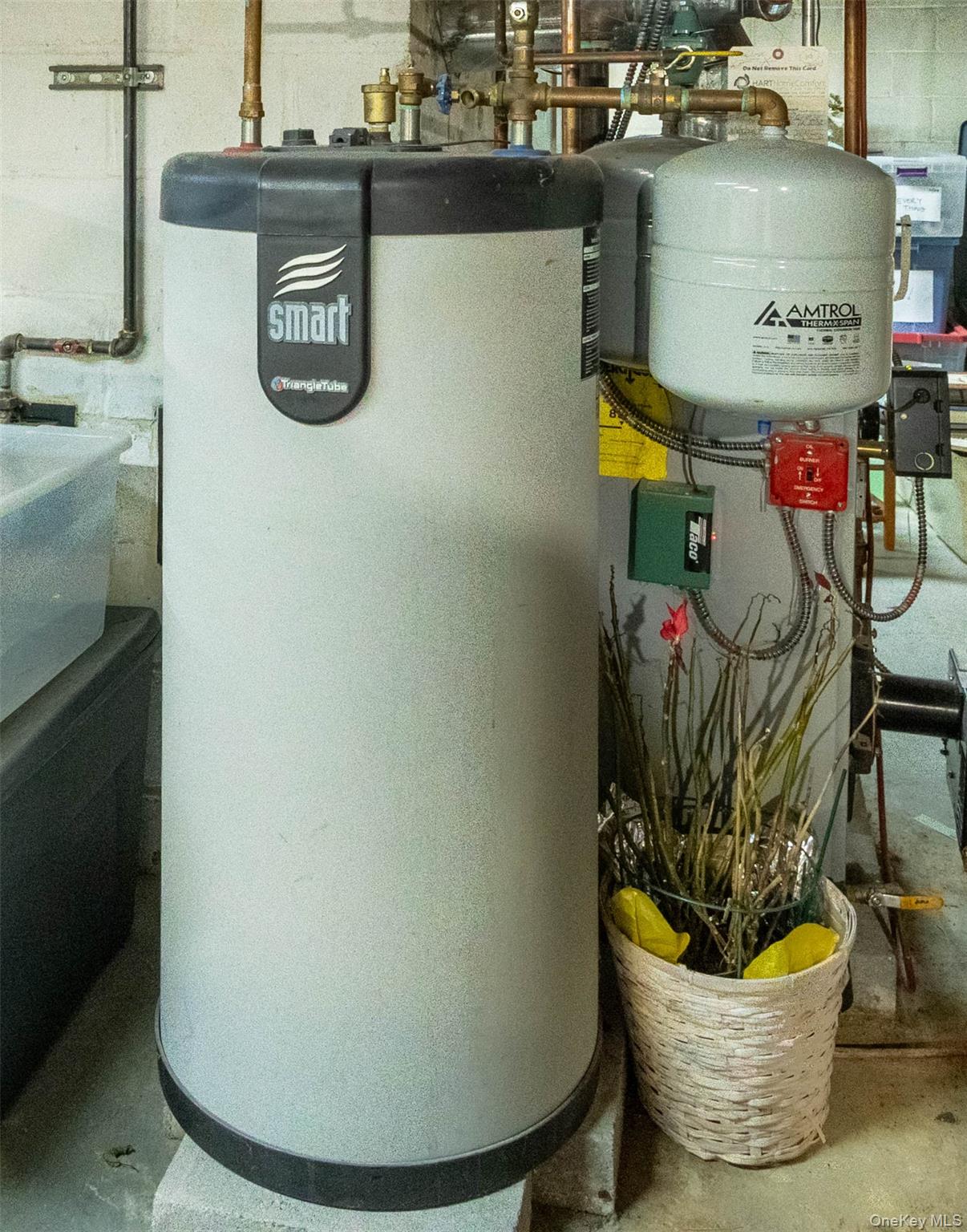 90 Sunset Road Bay Shore, NY 11706 - Photo 31 of 31 Mechanical room featuring a water heater and an expansion tank