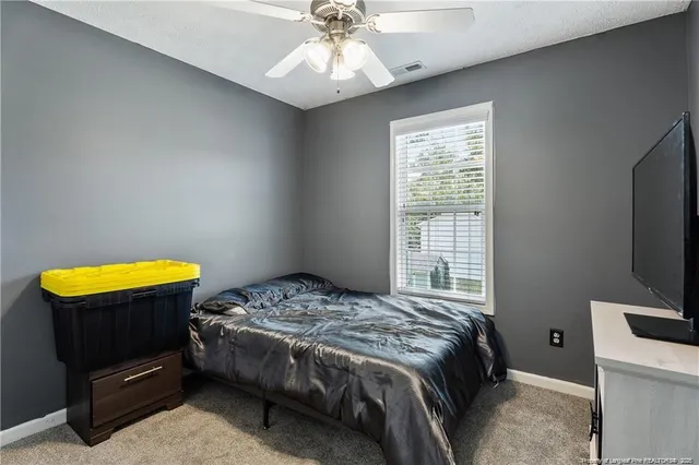 a bedroom with a bed and a tv