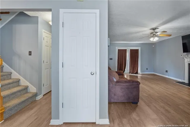 a view of a hallway with wooden floor and workspace