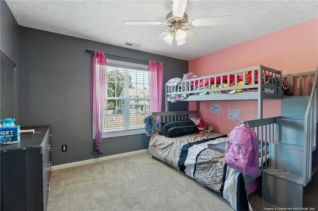 a bedroom with bed and a chandelier